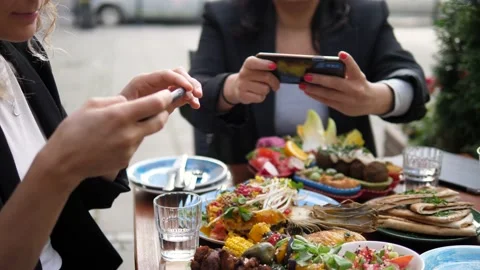 Hands of two people taking photos and recording food they ordered for dinner. Stock Footage 139841149