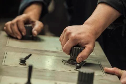 The hands of the two working switch levers and knobs Stock Photos