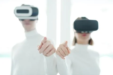 Hands of two young developers of futuristic apps or technologies in vr headsets Stock Photos