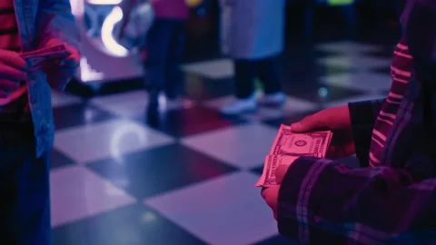Hands of Two Young Kids Counting Cash in Gaming Arcade Stock Footage 299718704