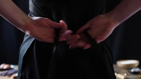 Hands tying an apron - shot from behind Stock Footage 132558476