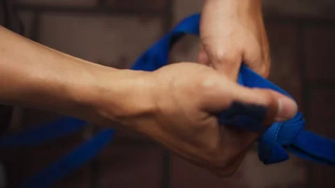 Hands Tying Blue Webbing Strap in Close Up Stock Footage 344235815