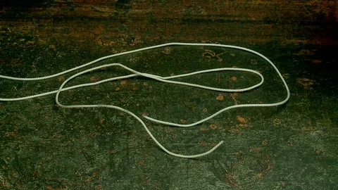 Hands tying reef knot Stock Footage 82102549