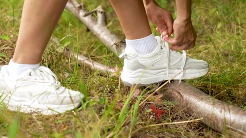 Hands Tying Sneaker Laces on Forest Log Stock Footage 314006160