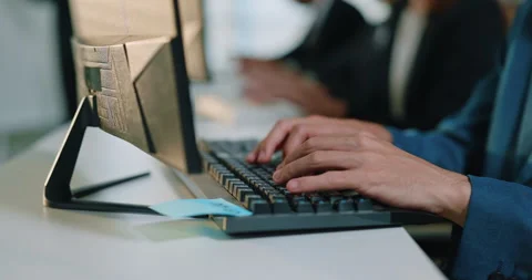 Hands type on computer keyboard near desktop monitor during office routine Stock Footage 347832125