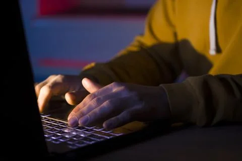 Hands types on a laptop keyboard. Stock Photos