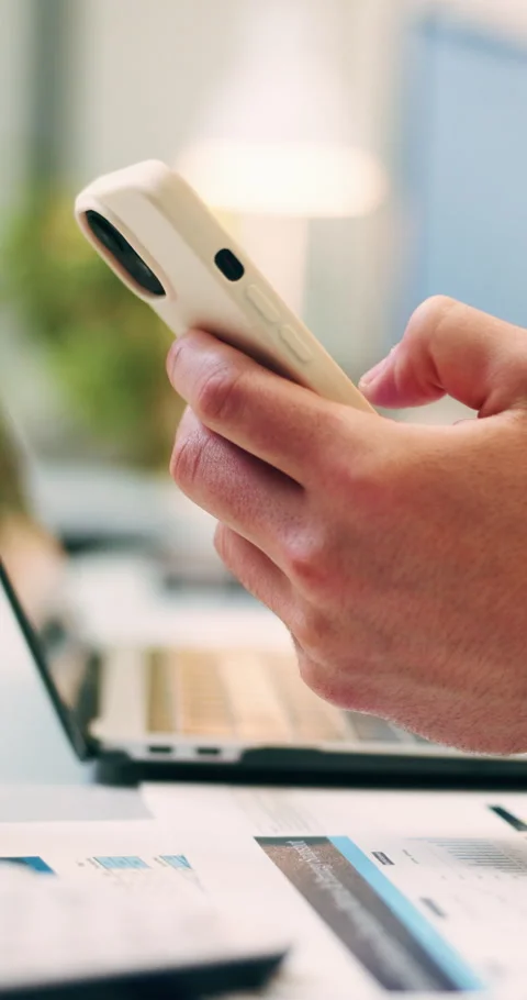 Hands, typing and laptop in office with phone notification, marketing analytics Stockbeeldmateriaal 336326130