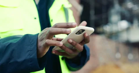 Hands, typing and phone on construction site with schedule, building app and Stock Footage 336795187