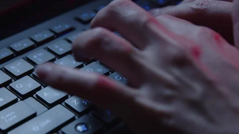 Hands Typing on a Backlit Keyboard at Night in a Dim Workspace Stock Footage 281759577