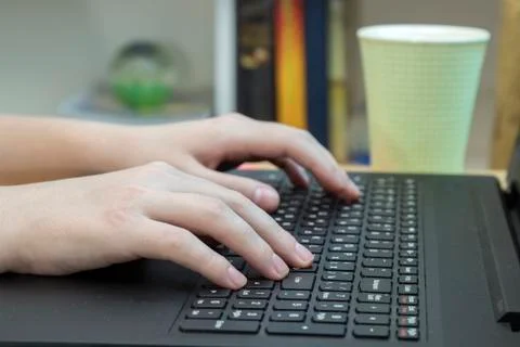 Hands typing on black keyboard, close up Stock Photos