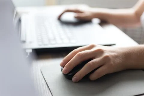 Hands typing on black laptop computer keyboard and mouse Stock Photos