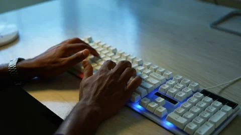 Hands typing on blue backlit keyboard, Close view of hands typing on a whit.. Vídeos de archivo 346463085