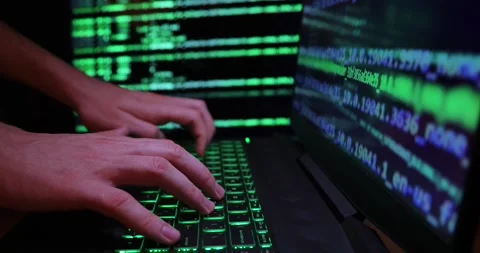 Hands typing code on a laptop keyboard, hacking or programming concept Stock Footage 263043239