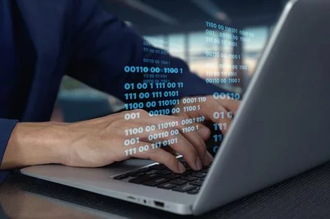 Hands Typing Code on Laptop in Modern Workspace with Binary Data Stock Photos