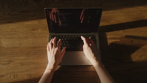 Hands Typing Code on Laptop in Sunlight 스톡 동영상 306574459
