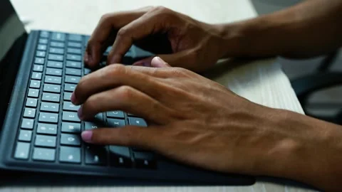Hands typing on computer keyboard, Close-up of adult hands typing on a blac.. Stock Footage 347858346