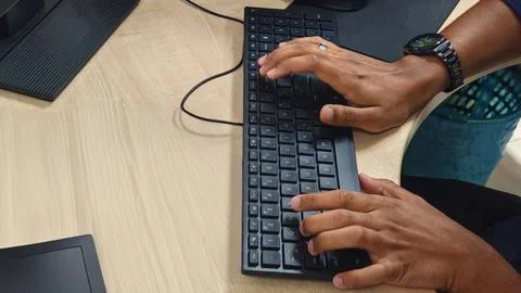 Hands Typing on Computer Keyboard at Desk 스톡 사진