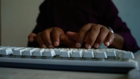 Hands typing on computer keyboard in dim light, Close-up of hands typing on.. Stock Footage 346460964