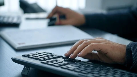 Hands typing on computer keyboard, man working on pc in office Видео 105396878