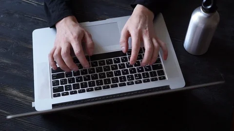 Hands typing on computer keyboard, moving camera, business man working on laptop Stock Footage 121098590