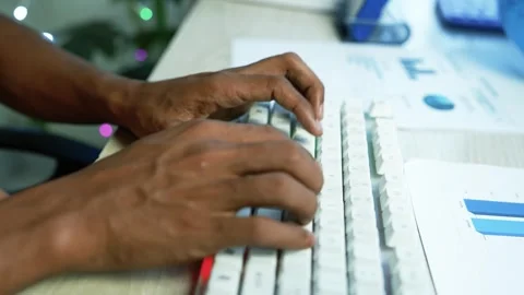 Hands typing on a computer keyboard in an office, Close view of hands typin.. Stock Footage 345119002