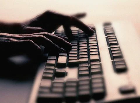 HANDS TYPING ON COMPUTER KEYBOARD Stock Photos