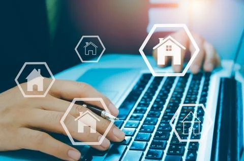 Hands typing on computer laptop Buying, selling and renting houses or real .. Stock Photos