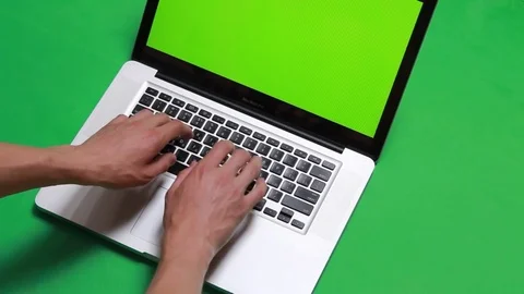 Hands typing on a computer over green screen background Stock Footage 78984697