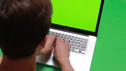 Hands typing on a computer over green screen background Stock Footage 78984722