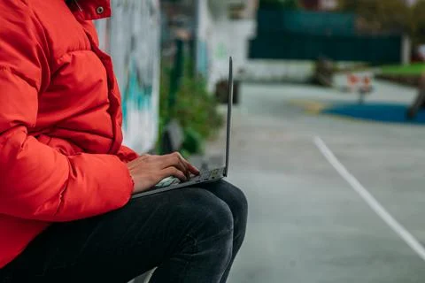 Hands typing on the computer in the street Stock Photos