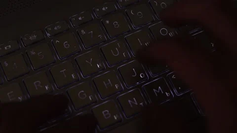 Hands typing in the dark on illuminated keyboard Stock Footage 196223019
