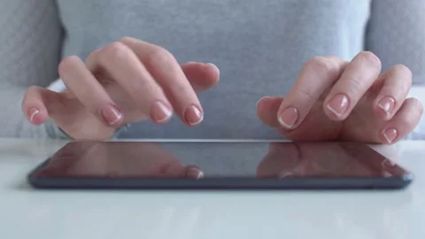 Hands typing on a digital tablet on white table Stock Footage 333836504