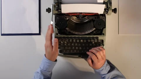 Hands typing a document on an old vintage typewriter, composing content on white Stock Footage 322166918
