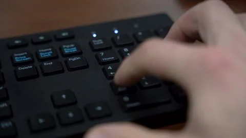 Hands Typing Fast on Black Computer Keyboard and Number Pad Close Up Stock Footage 323398926