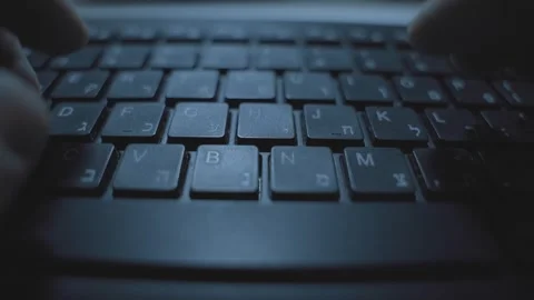 Hands typing fast on computer keyboard with Hebrew letters. Hacker or spy 스톡 동영상 332595998