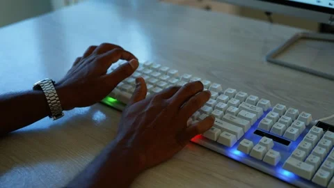Hands typing on glowing keyboard, Close-up of hands typing on a white compu.. Video stock 346463116