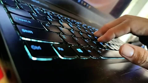 Hands typing on a glowing laptop keyboard Stock Footage 289922368