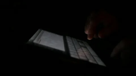Hands typing on Ipad with black background Stock Footage 10892336