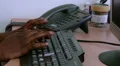 Hands typing on a keyboard and answering phone HD Footage