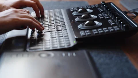 Hands Typing on Keyboard and Using Color Grading Control Panel in Studio Stock Footage 345691331