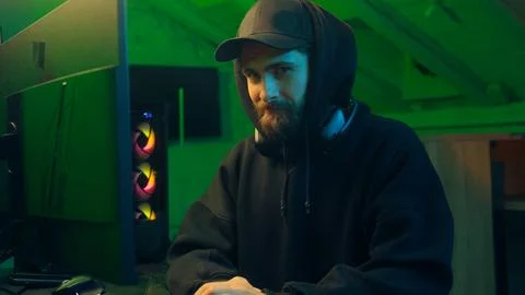 Hands typing keyboard computer Caucasian man programmer hacker looking at camera Stock Photos
