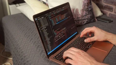 Hands typing on a keyboard creating a web-based computer program in an Stock Footage 205190431