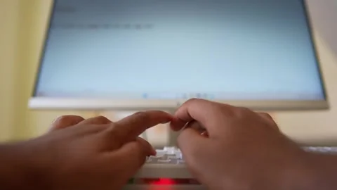 Hands typing on a keyboard in front of a computer Stock Footage 318056567