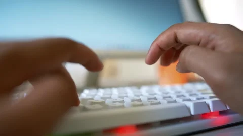 Hands typing on a keyboard in front of a computer Stock Footage 318056572