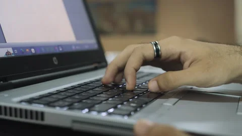 Hands typing on keyboard of laptop from side view Stock Footage 248856465