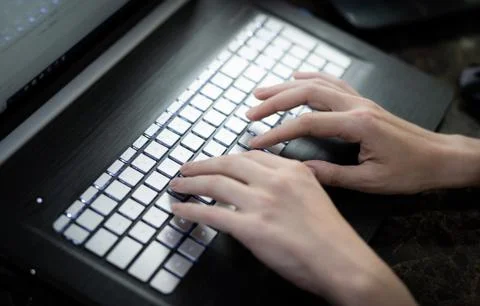 Hands typing on keyboard Stock-Fotos