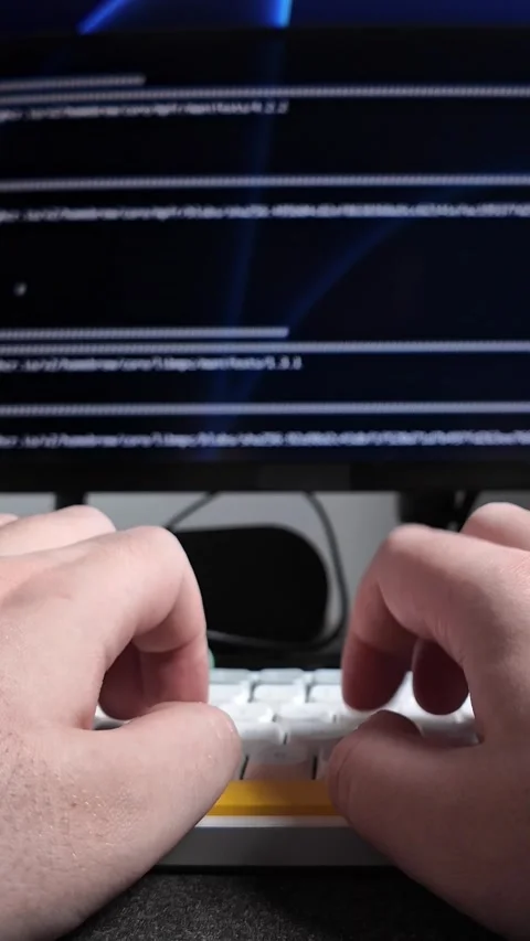 Hands typing on a keyboard, programming code on blurred screen, symbolizing.. 動画素材 320174412