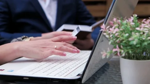 Hands typing on the keyboard in a summer cafe Stock Footage 75475472