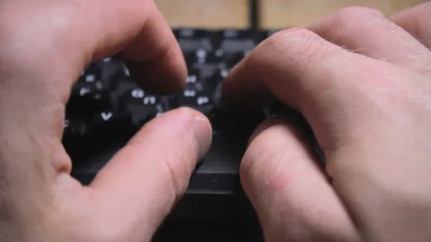 Hands typing on keys of input device, office work at computer, closeup fingers Video stock 188590623