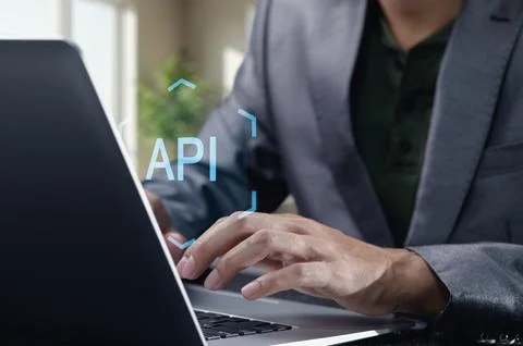 Hands Typing on Laptop with API Concept in Focused Workspace Foto stock